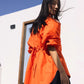 Orange embroidered shirt with floral detailing styled in a contemporary outdoor setting
