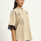 Vanilla beige shirt with floral embroidery and knitted sleeve details