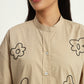Vanilla beige shirt with floral embroidery and knitted sleeve details
